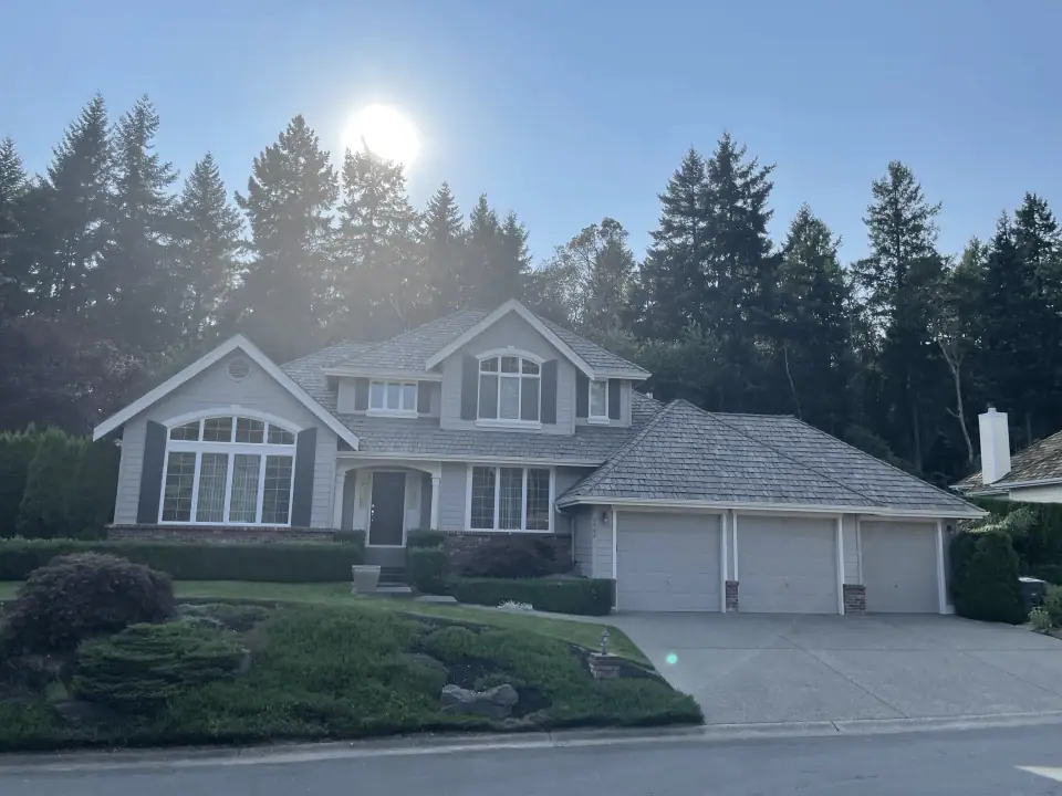 Cedar shake roof treated in a grey tone on a two-story home
